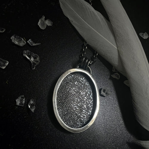 silver and black pendant necklace